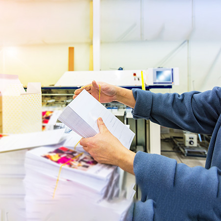 man-checking-and stacking-paper-to-send-to-direct-mail