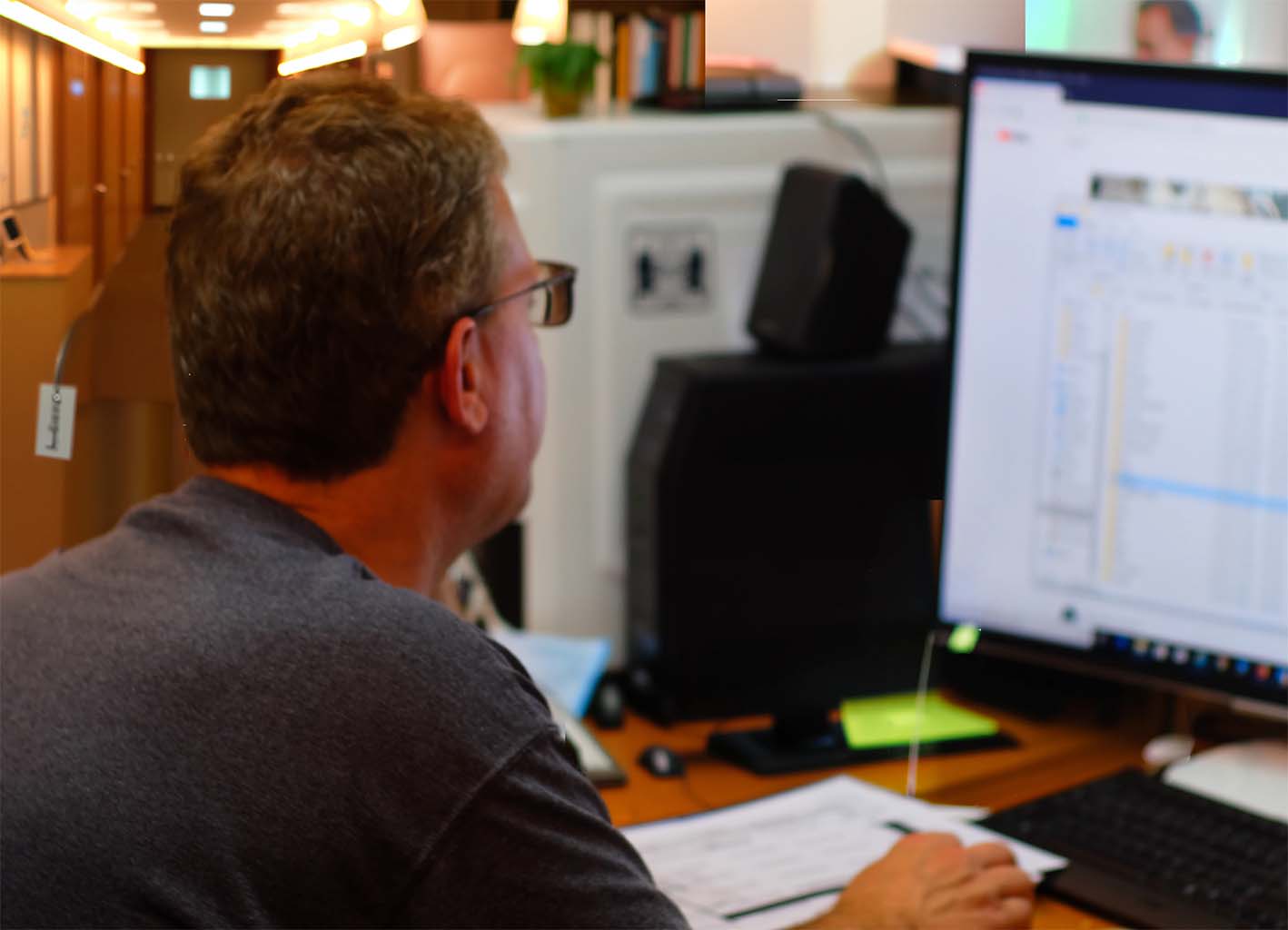 about-us-John-Brake-working-at-his-desk